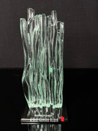 8 inch tall Canadian handcrafted Kiln Formed casted Clear Glass waterfall award statue, that sits on top of a black glass base with etching of a logo and a maple leaf. the award stands in front of a black studio background