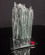 6 inch tall Canadian handcrafted Kiln Formed casted Clear Glass waterfall award statue, that sits on top of a black glass base with etching of a logo and a maple leaf. the award stands in front of a black studio background