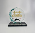 6 inch tall handcrafted glass award with colored glass gems fused into the front of the award in the shape of a crescent moon. the award has an multi colored etching of Vancouver landmarks, Canadian maple leafs and an orca killer whale. the award has a black glass base with clear glass gems fused into the base. the award stands in front of a studio background
