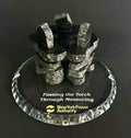 3 Handcrafted 2.5 inch tall Chipped edge black polished granite inukshuks stand in a friendship circle on top of a clear glass base with etching on top, standing in front of a black studio background 