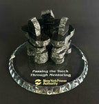 3 Handcrafted 2.5 inch tall Chipped edge black polished granite inukshuks stand in a friendship circle on top of a clear glass base with etching on top, standing in front of a black studio background 