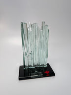 Glass Waterfall sculpture on a black base with 'Champions' and a maple leaf logo on a gray background