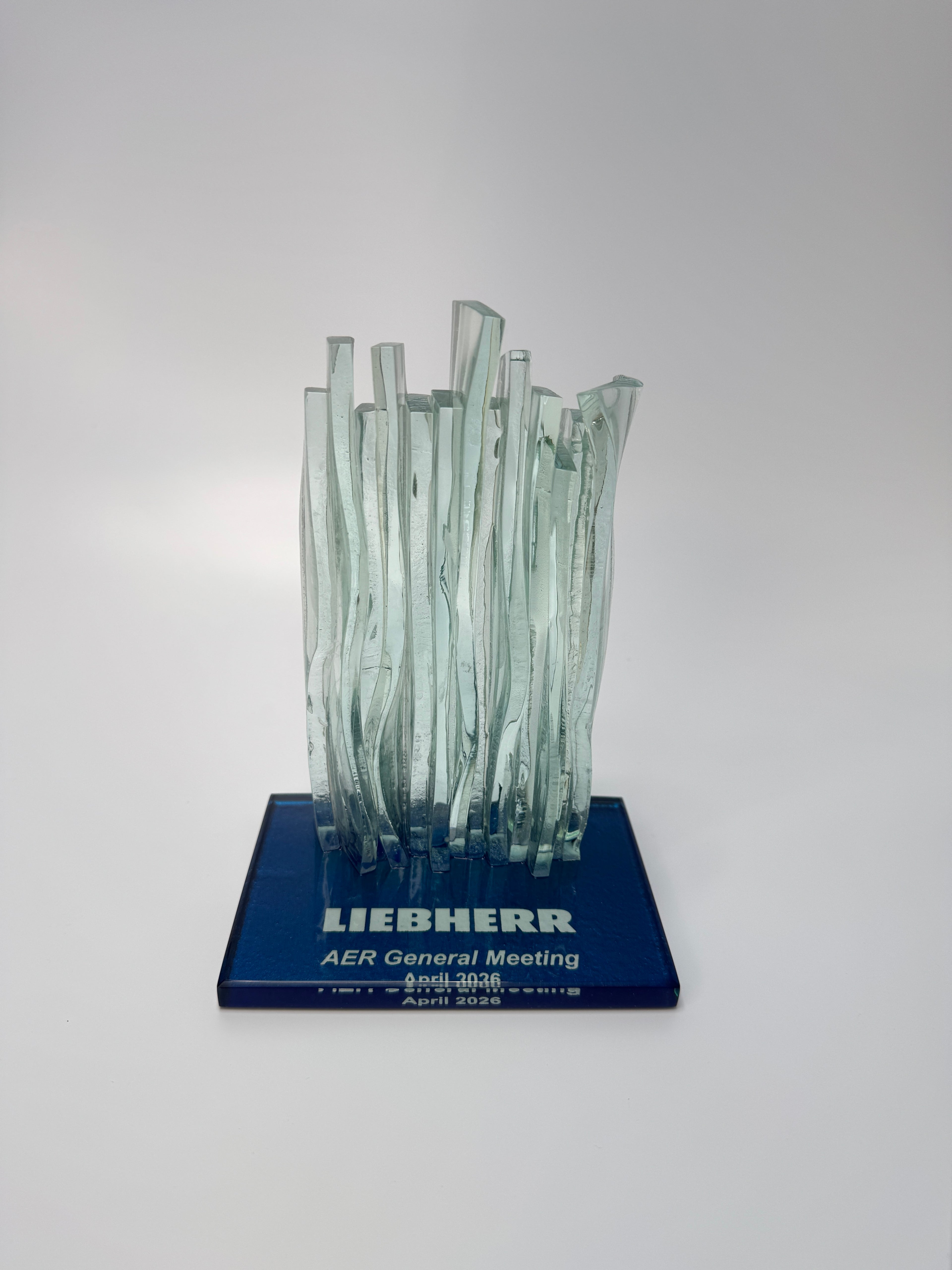 Glass Waterfall sculpture on a blue base with 'LIEBHERR' branding