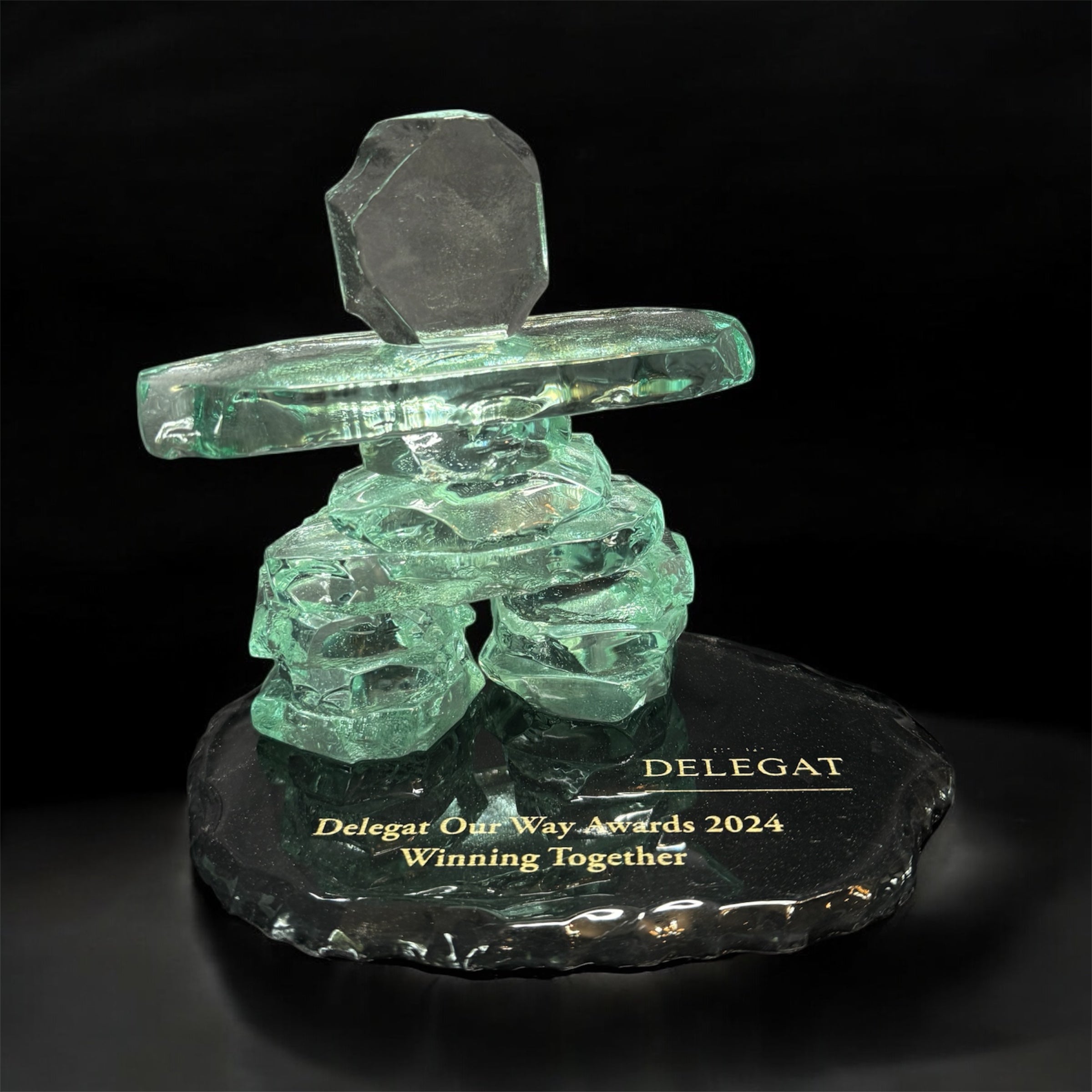 Inukshuk award statue on a dark base with winning award