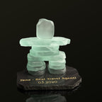 Handcrafted 4.5 inch tall frosted glass inukshuk, on top of a Black polished granite base with a chipped edge finish and gold etching on top